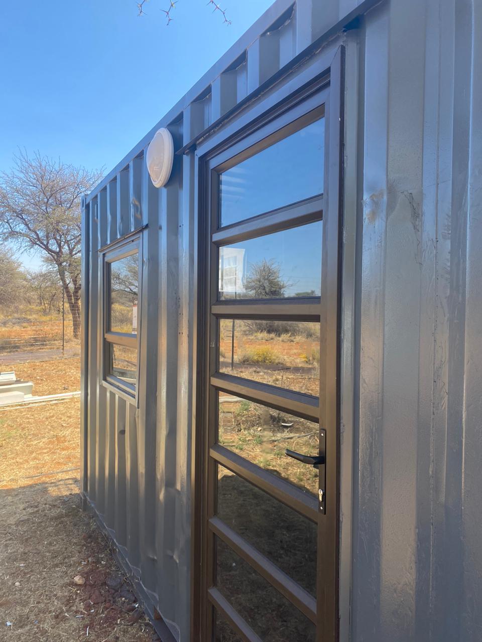 Close-up of exterior cladding and window finishings on a converted container cabin